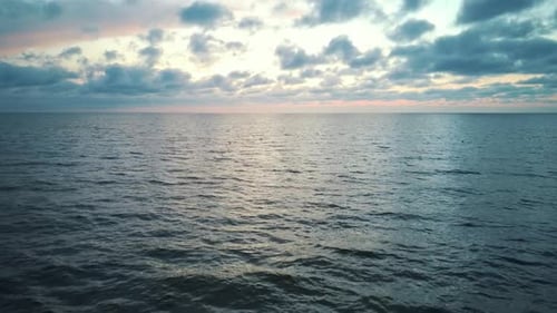 Dron Flying Backward
Over SeaAfter Sunset. Beautiful Sea Sunset Flyover Aerial Drone Shoot. Sunrise