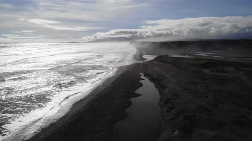 Fog Rolling Over Black Sand Beach and River Estuary