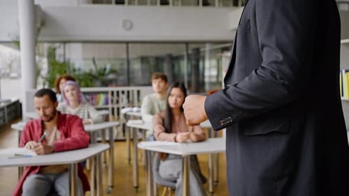 Professor Teaching Diverse Students in Bright Classroom Setting