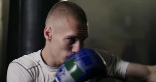 Determined Male Boxer Training Throwing Punches