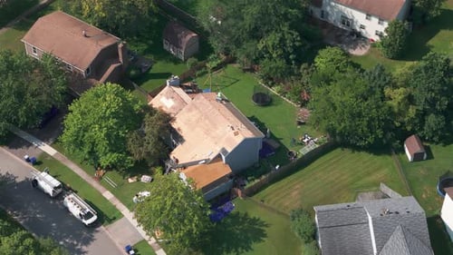 Wide Drone View of Roofers Installing a New Roof on an Residential Building
