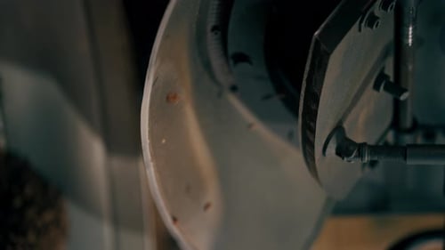 Vertical Video Closeup of a Coffee Roasting Factory the Process of Pouring Coffee Into the Drum