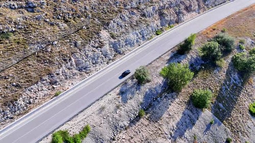 Winding Mountain Road Embraced by Nature s Serenity During Bright Daylight in a Remote Location