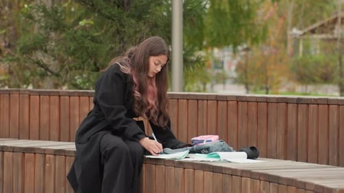 Focused Teen Girl Studying in the Park