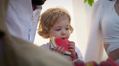 Loving Father and Child Eating Watermelon Together