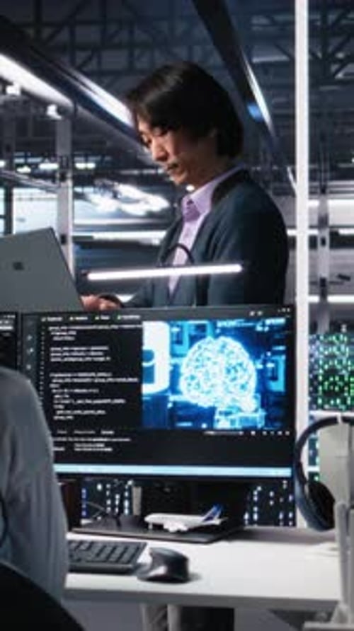 Vertical Video Team Leader Supervising Technicians in Server Room Using AI