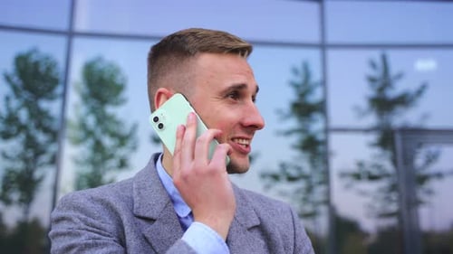 Happy Young Man Talking on the Mobile Phone on the Street Slow Motion