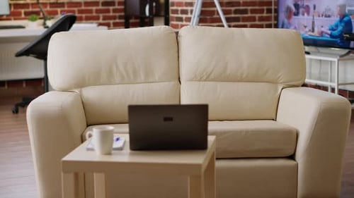 Empty Modern Living Room Office with Couch and Laptop