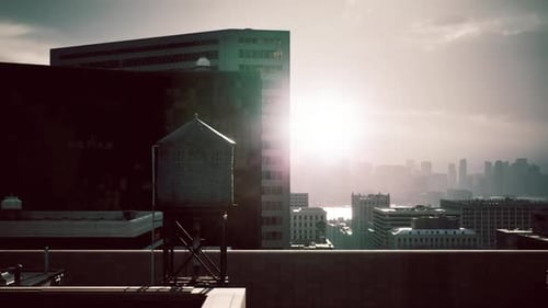 Sunlight Breaking Through Urban Structures at Twilight Over the City Skyline