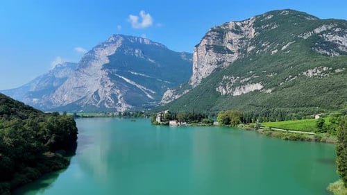 Majestic clouds gliding over a serene lake surrounded by mountains