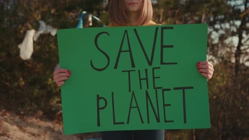 Close Up Hands Woman Activist Holding Encouraging Green Poster Save the Planet Standing at Landfill