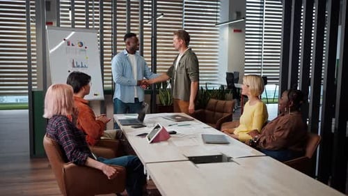 Business Meeting Success with Team Handshake and Applause