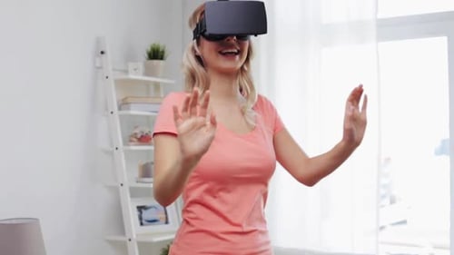 Woman wearing VR headset interacts in bright living room