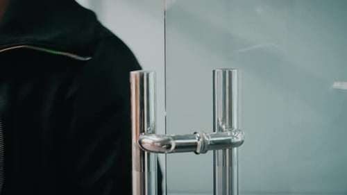 Opening a Glass Door in a Modern Building With Clear Design and Metal Elements Filmed in High