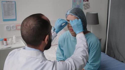 Doctor Checks Patient After Nose Surgery