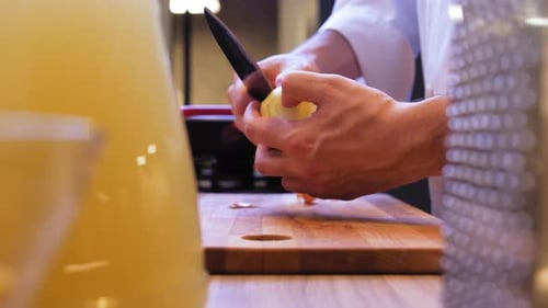 Chef Peeling Vegetable in Kitchen Environment