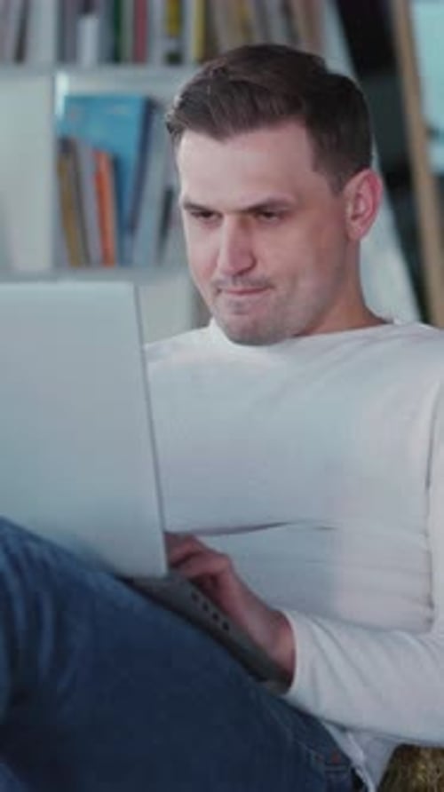 Adult Using Laptop Computer Indoors in Vertical Video