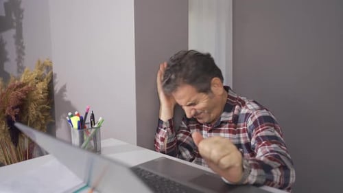 Businessman working in home office makes a mistake and gets upset.