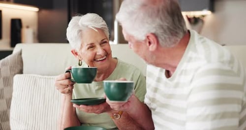 Senior Couple Enjoying Coffee and Laughing Together Indoors