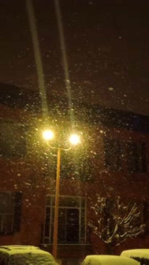 Gentle Snowfall Near Vintage Streetlamp at Night, Vertical