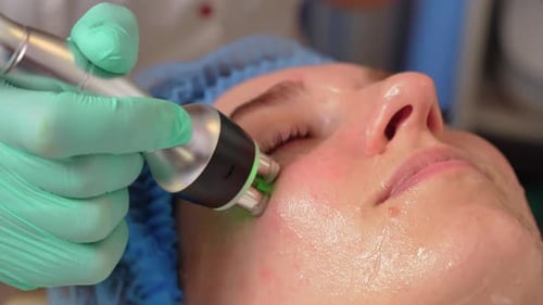 Close Up of Ultrasound Cavitation Facelift Procedure Woman Patient in Cosmetology Clinic Doctor
