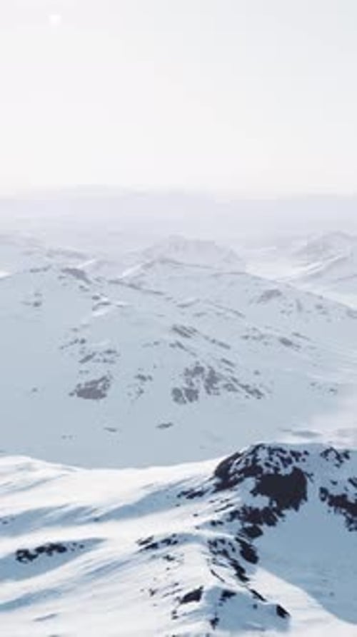 A Snowcovered Mountain Range with Majestic Peaks in the Distance