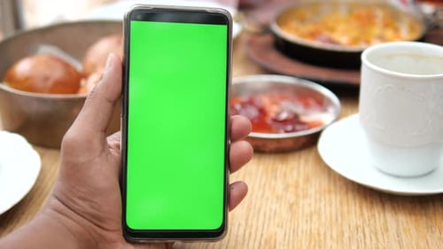 Pov Shot of Young Man Hand Using Smart Phone with Green Screen at Cafe