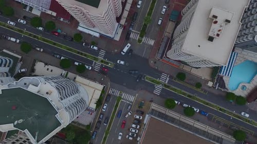 Aerial Video Aerial View of Traffic on a Narrow City Street with Cars and Pedestrians in Motion