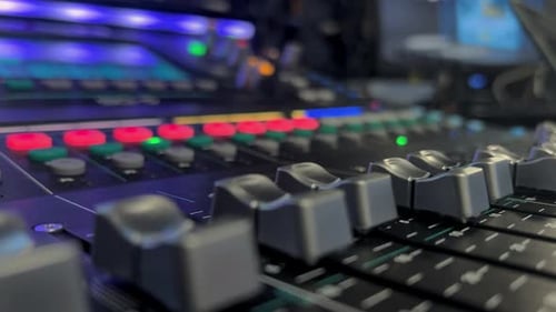 Audio Mixing Console with colorful lights in studio