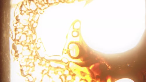 Abstract Bubbles Swirling in a Gold Liquid