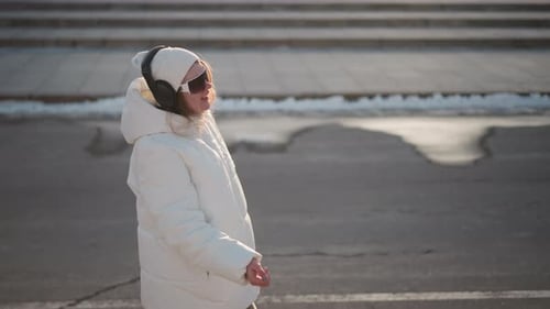Young Artist Walking Joyfully in Winter Sunlight