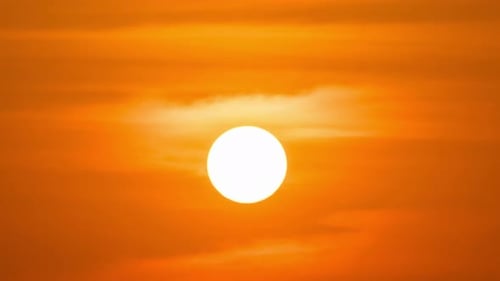 Peaceful sunset time-lapse with warm golden light and fast-moving clouds.