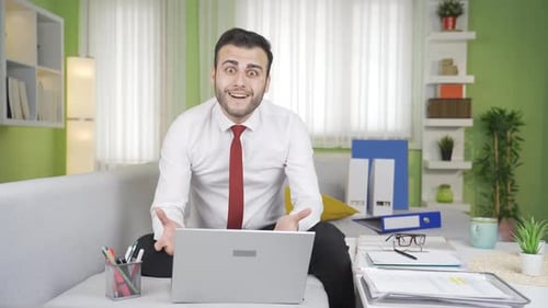 Shocked Man Sees Laptop on Sofa