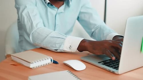 Man Working on Laptop at Home Office Desk