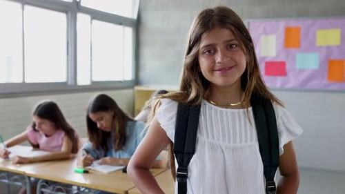 Smiling Girl with Backpack in Classroom