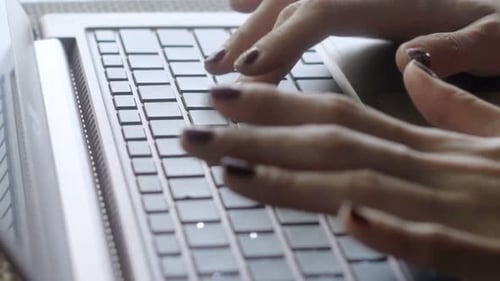 Woman Typing on Laptop Sitting in Cafe 30s
