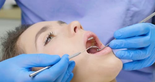 In a professional practice, a dentist checks the dentition of the patient, and she is happy with t