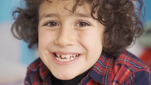 Funny boy looking at camera and laughing.