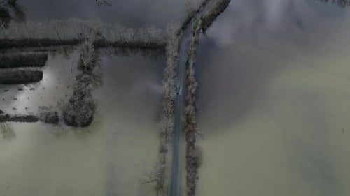 Aerial view of flooded road with vehicle, France.