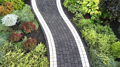 Beautiful Garden Pathway Surrounded by Lush Greenery in a Vibrant Landscape