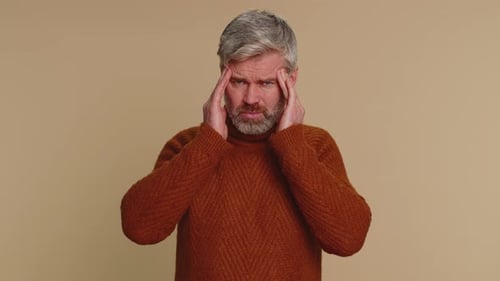 Adult Man Rubbing Temples in Pain