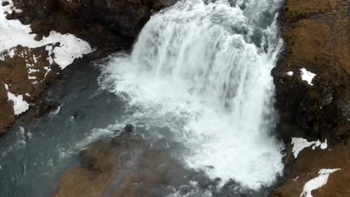 A 4K drone, aerial and unique and cinematic shots of melted water flowing from a glacier.