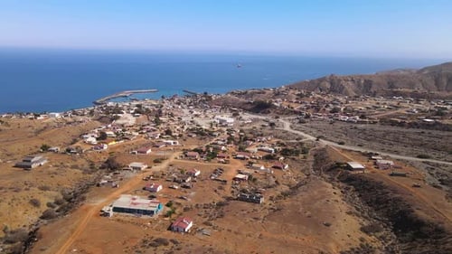 Aerial wide view of Cedros Island village and coastline under sunny skies