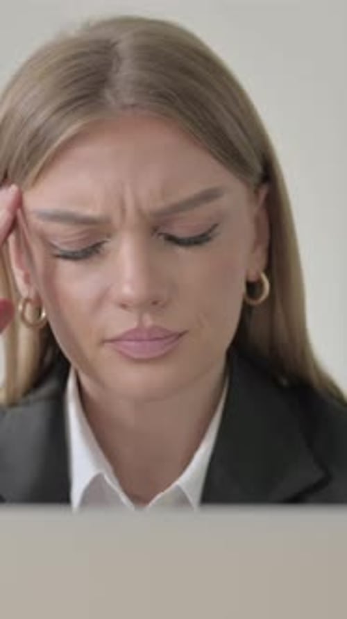 Close Up of Young Businesswoman with Headache Working on Laptop, Vertical Video