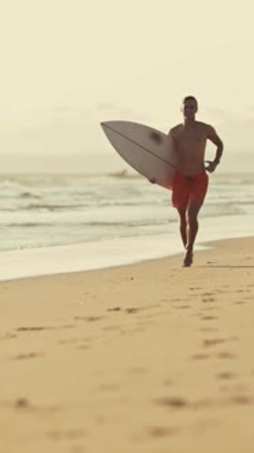 Surfer Running on the Beach with Surfboard