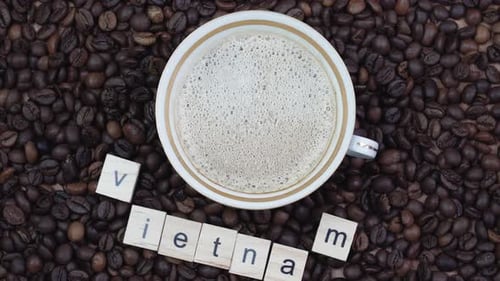Top View of a Cup of Coffee on a Background Coffee Beans with the Inscription Vietnam