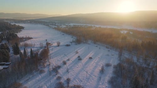 an Aerial View of a Snowy Landscape at Sunset