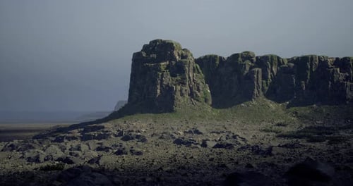 Dramatic Rocky Landscape with Lush Greenery During Twilight Hours
