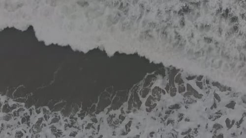 Slow Motion Of Foamy Waves Splashing In The Sea - birdseye view, top-down