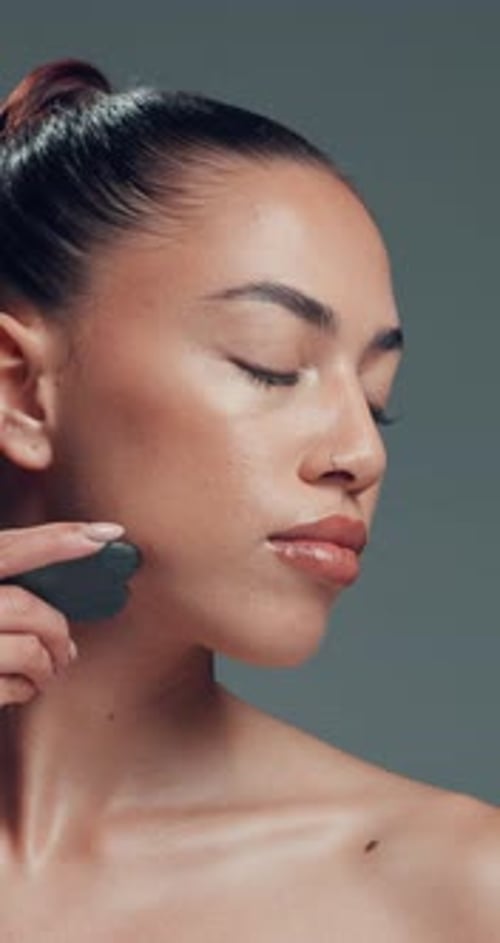 Gua sha, massage and skincare with woman in studio for cosmetics, dermatology or wellness routine